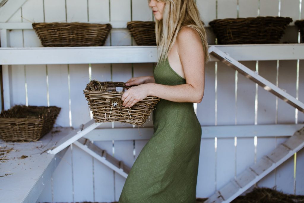 woman carrying storage basket to place on shelf