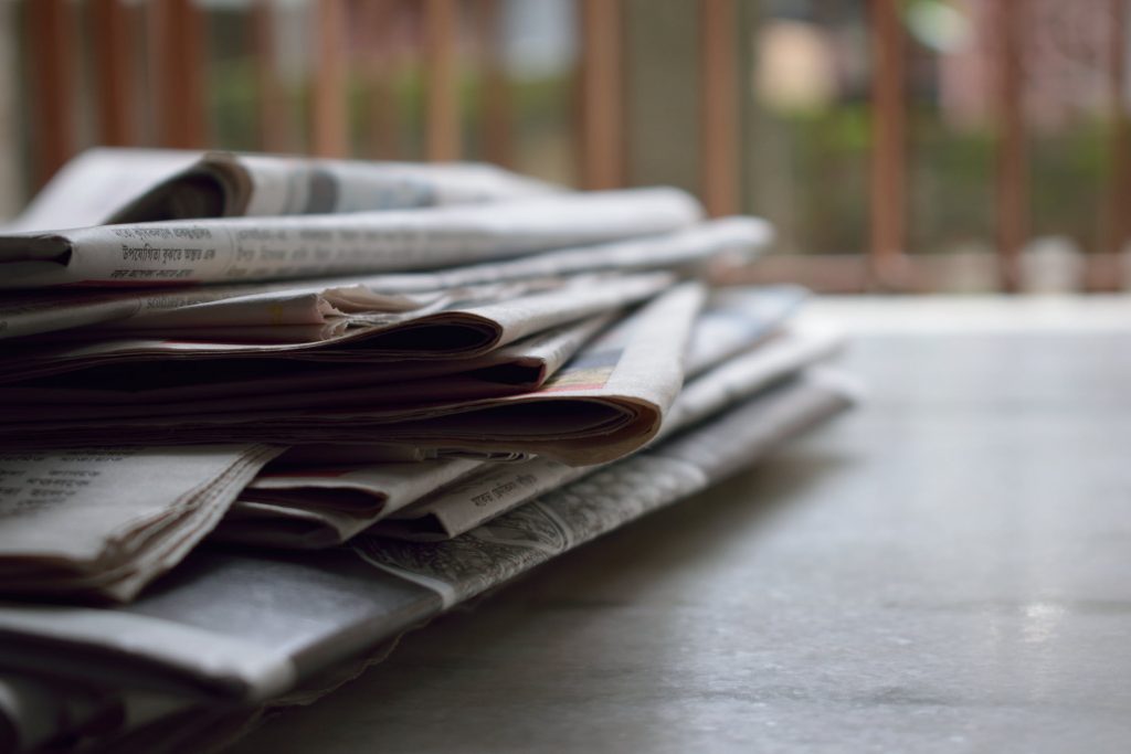 Newspaper pile on porch