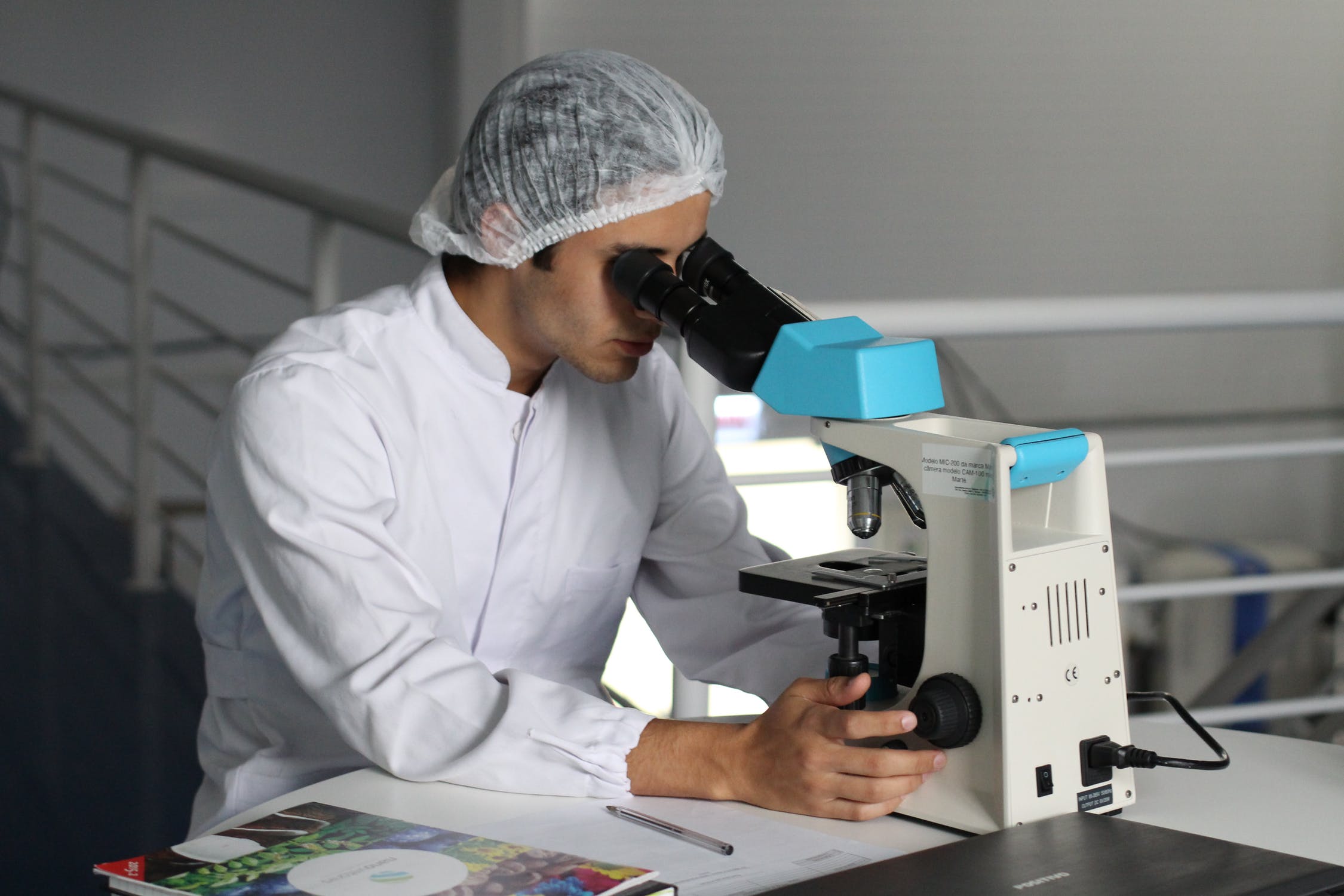 Scientist looking through microscope